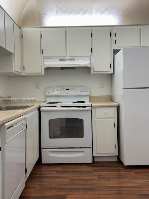 9235 Southwest 8th Street, Unit 510 Boca Raton, FL 33428 - Photo 7 of 23 a kitchen with granite countertop white cabinets and white appliances