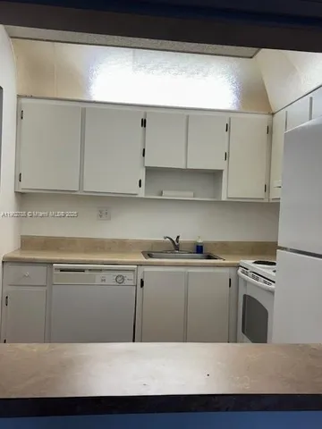 a white refrigerator freezer sitting in a kitchen