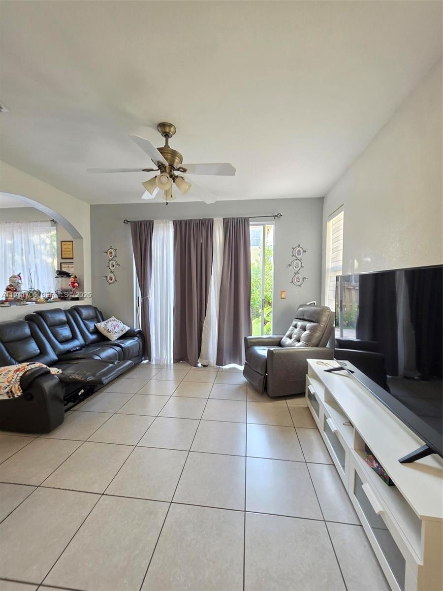 11702 Southwest 137th Place Miami, FL 33186 - Photo 14 of 30 a living room with furniture and a flat screen tv
