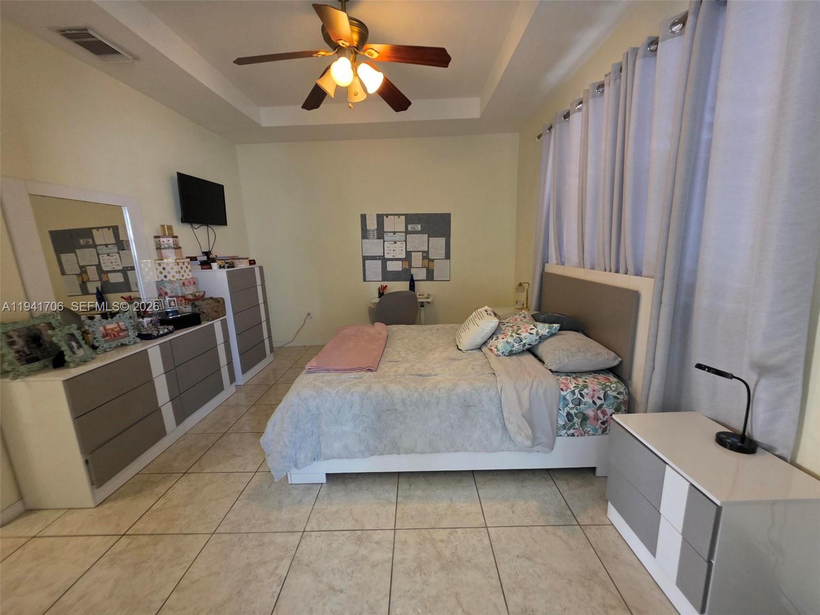 11702 Southwest 137th Place Miami, FL 33186 - Photo 18 of 30 a bedroom with a bed and furniture