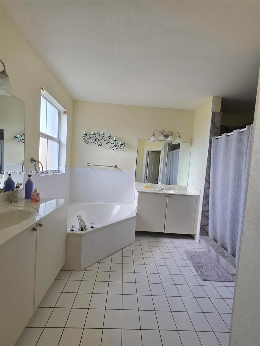 11702 Southwest 137th Place Miami, FL 33186 - Photo 20 of 30 a bathroom with a bathtub and a sink