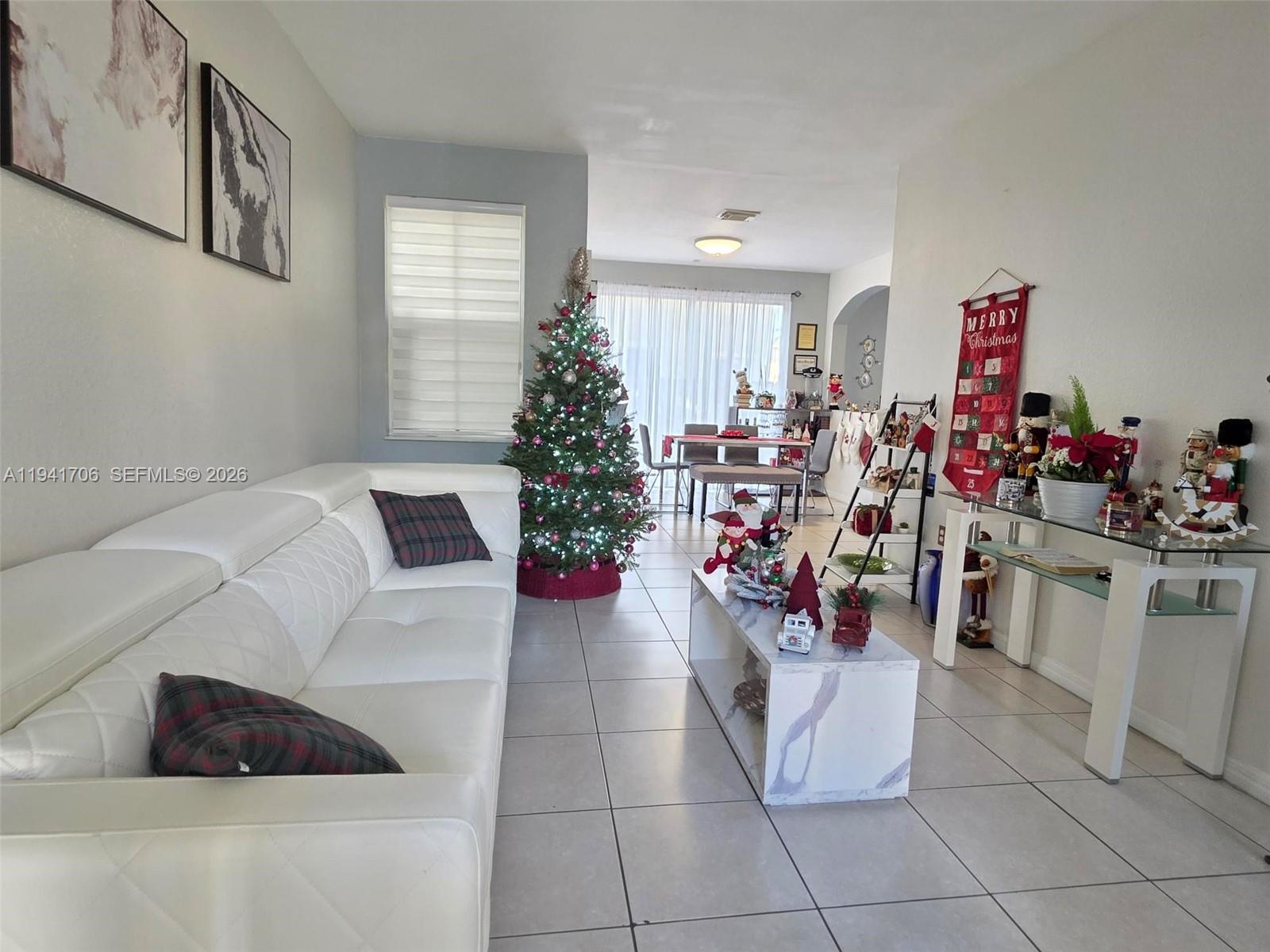 11702 Southwest 137th Place Miami, FL 33186 - Photo 2 of 30 a living room with furniture flowerpot and a window
