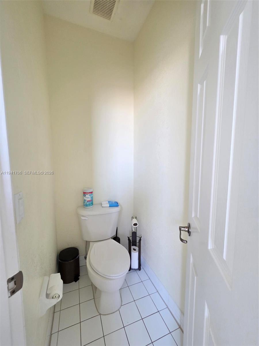 11702 Southwest 137th Place Miami, FL 33186 - Photo 22 of 30 a bathroom with a toilet and a rug