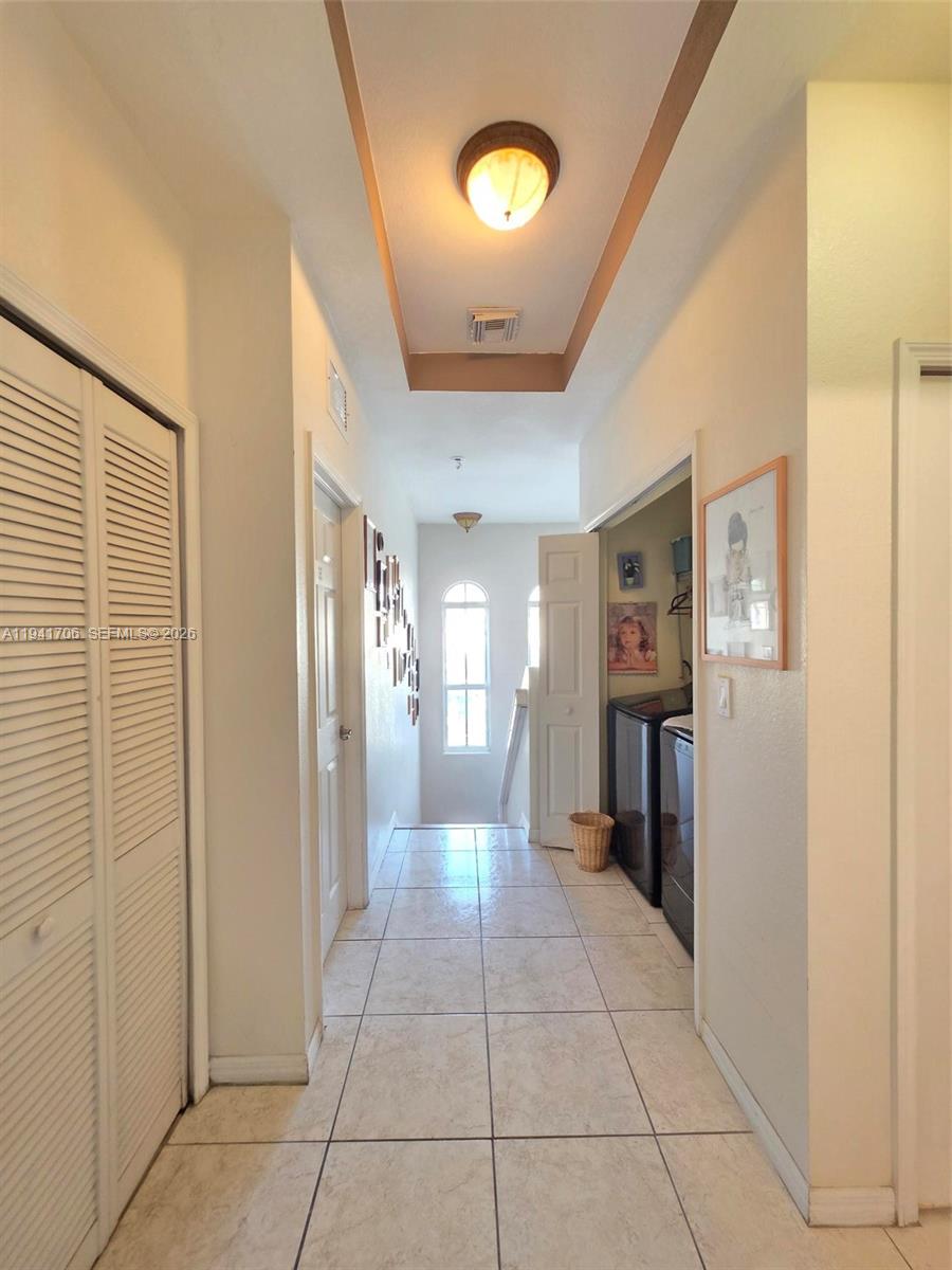 11702 Southwest 137th Place Miami, FL 33186 - Photo 25 of 30 a view of a hallway with wooden shelves