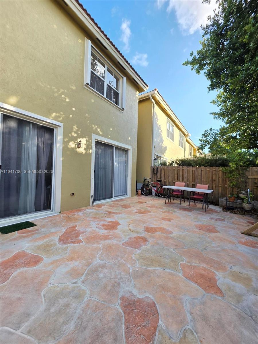 11702 Southwest 137th Place Miami, FL 33186 - Photo 28 of 30 a view of a house with backyard and trees