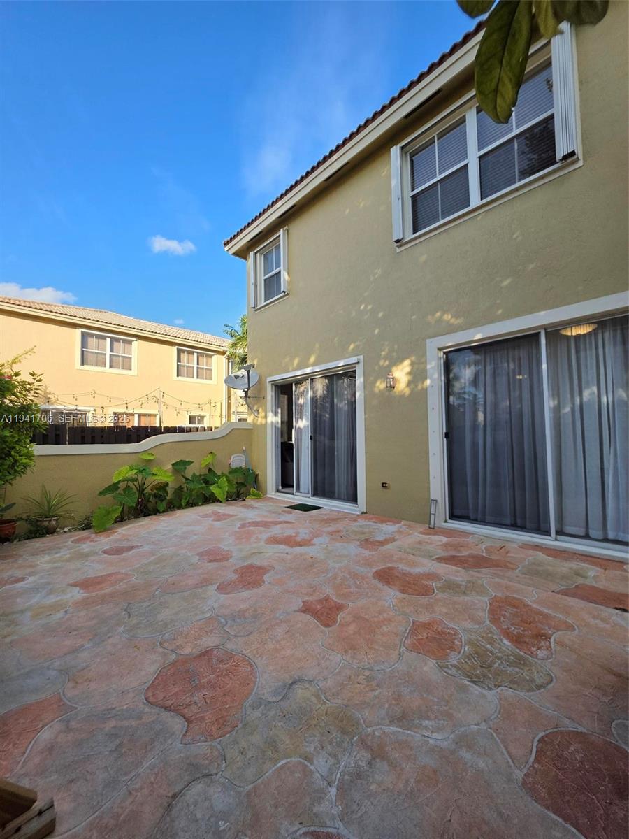 11702 Southwest 137th Place Miami, FL 33186 - Photo 30 of 30 a front view of a house with a yard and garage