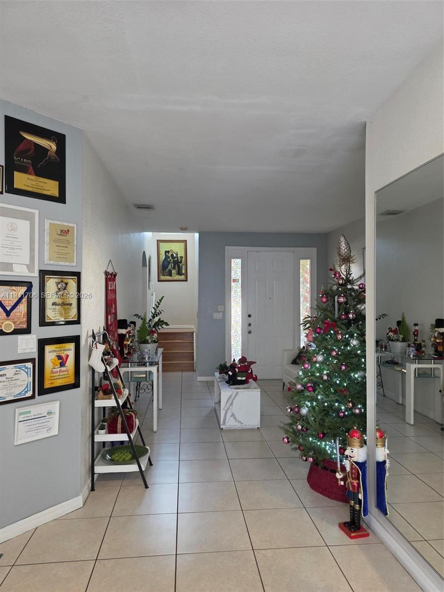 11702 Southwest 137th Place Miami, FL 33186 - Photo 3 of 30 a living room with furniture potted plants and flowers