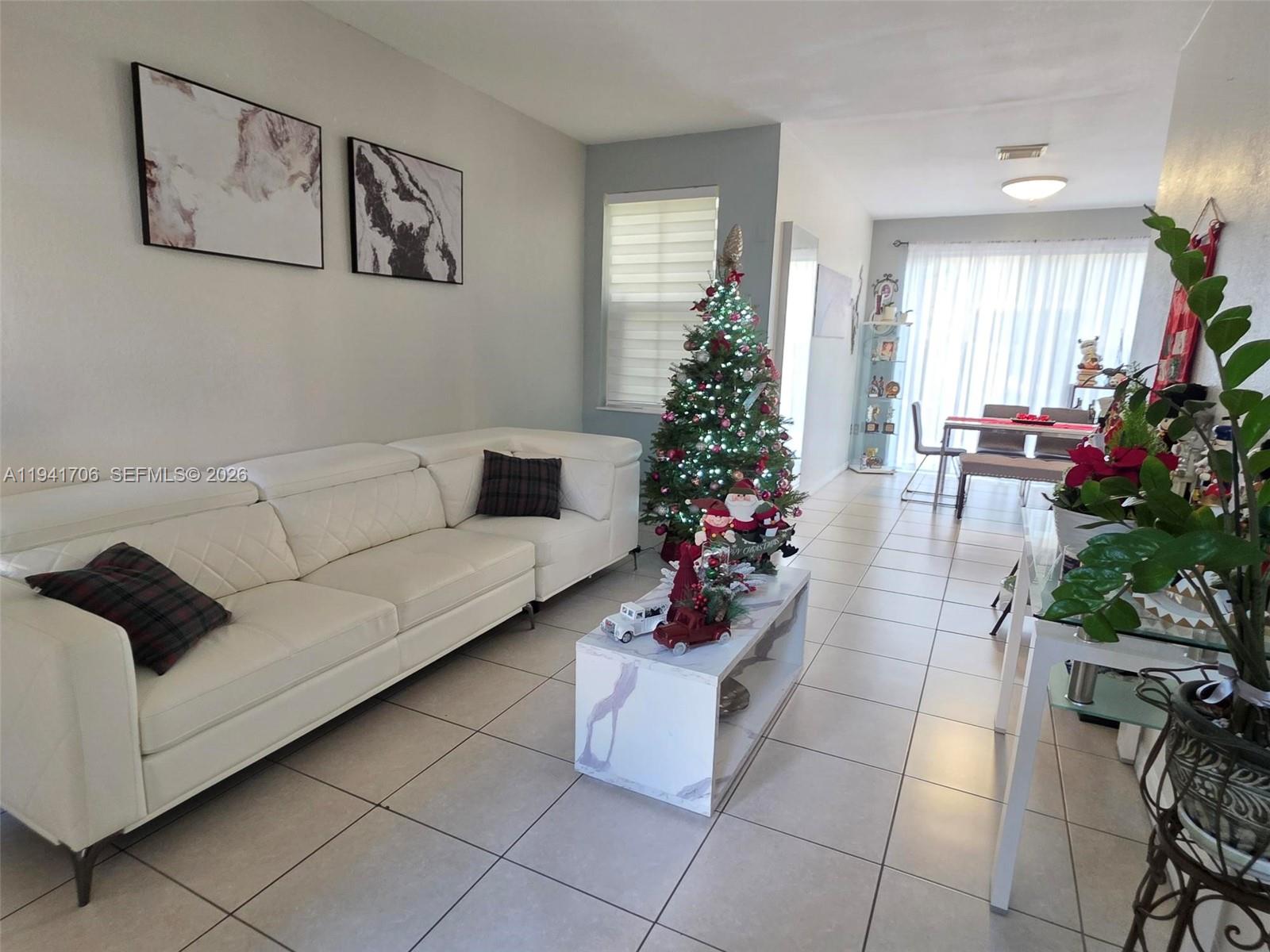 11702 Southwest 137th Place Miami, FL 33186 - Photo 4 of 30 a living room with furniture and a potted plant