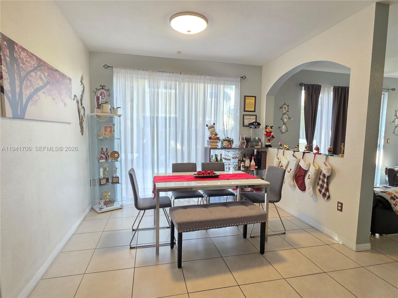 11702 Southwest 137th Place Miami, FL 33186 - Photo 5 of 30 a living room with furniture a rug and a painting on the wall