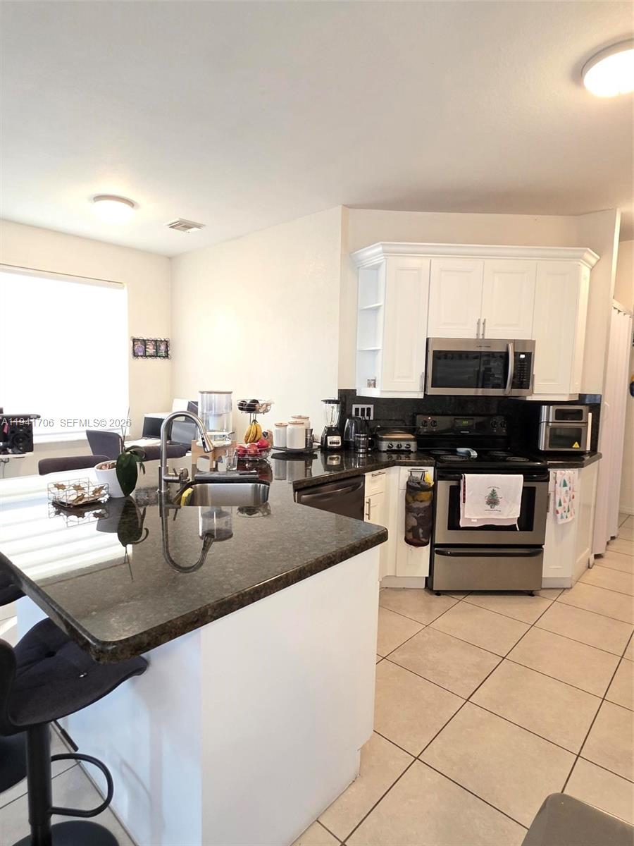 11702 Southwest 137th Place Miami, FL 33186 - Photo 8 of 30 a kitchen with counter top space and appliances