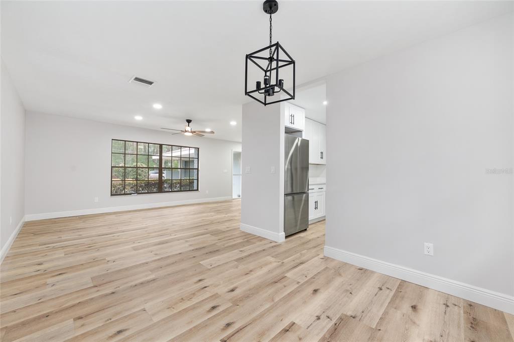 320 Southeast 41st Avenue Ocala, FL 34471 - Photo 15 of 45 a view of an empty room with wooden floor and windows