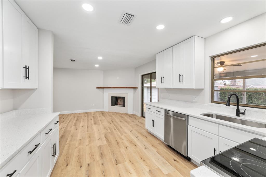 320 Southeast 41st Avenue Ocala, FL 34471 - Photo 16 of 45 a kitchen with a sink stove and cabinets