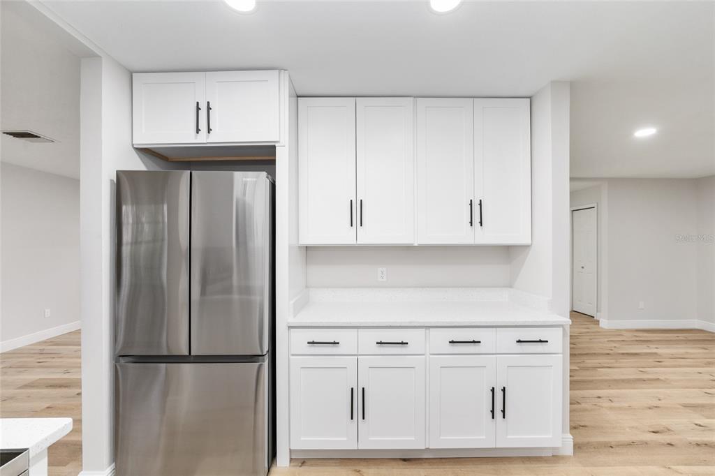 320 Southeast 41st Avenue Ocala, FL 34471 - Photo 17 of 45 a kitchen with stainless steel appliances granite countertop a refrigerator and white cabinets