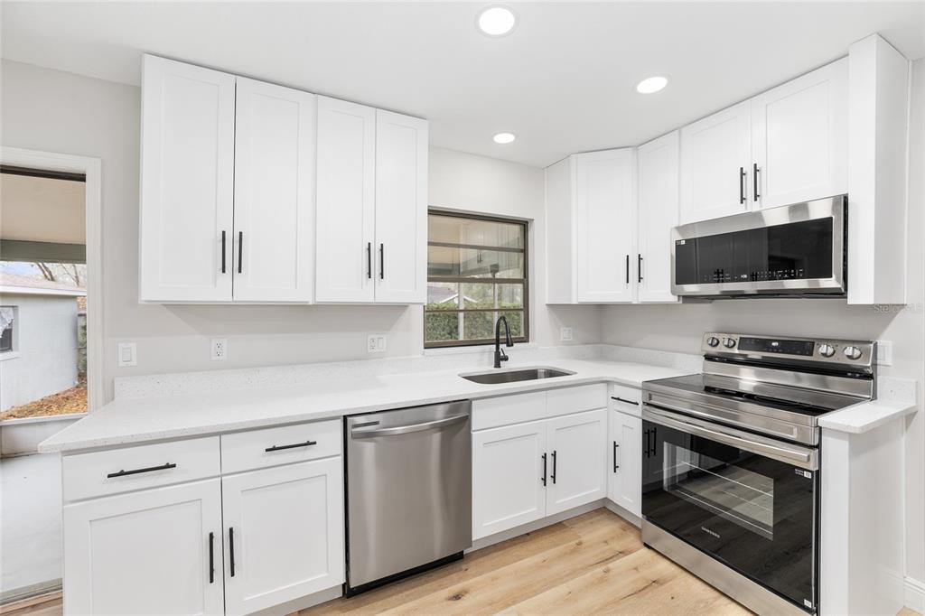 320 Southeast 41st Avenue Ocala, FL 34471 - Photo 19 of 45 a kitchen with cabinets appliances a sink and a counter top space