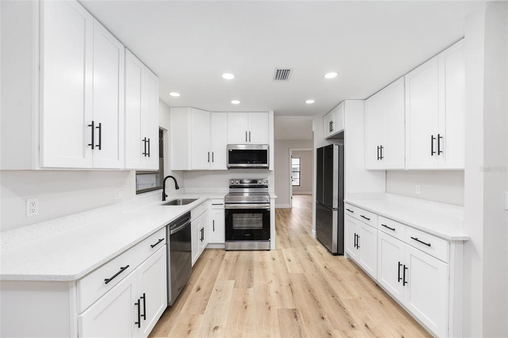 320 Southeast 41st Avenue Ocala, FL 34471 - Photo 20 of 45 a large kitchen with cabinets stainless steel appliances a sink and a counter top space