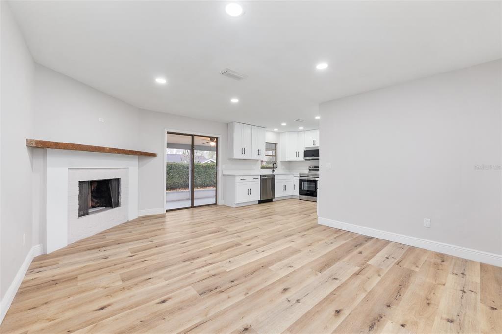 320 Southeast 41st Avenue Ocala, FL 34471 - Photo 24 of 45 a view of empty room with wooden floor and fireplace