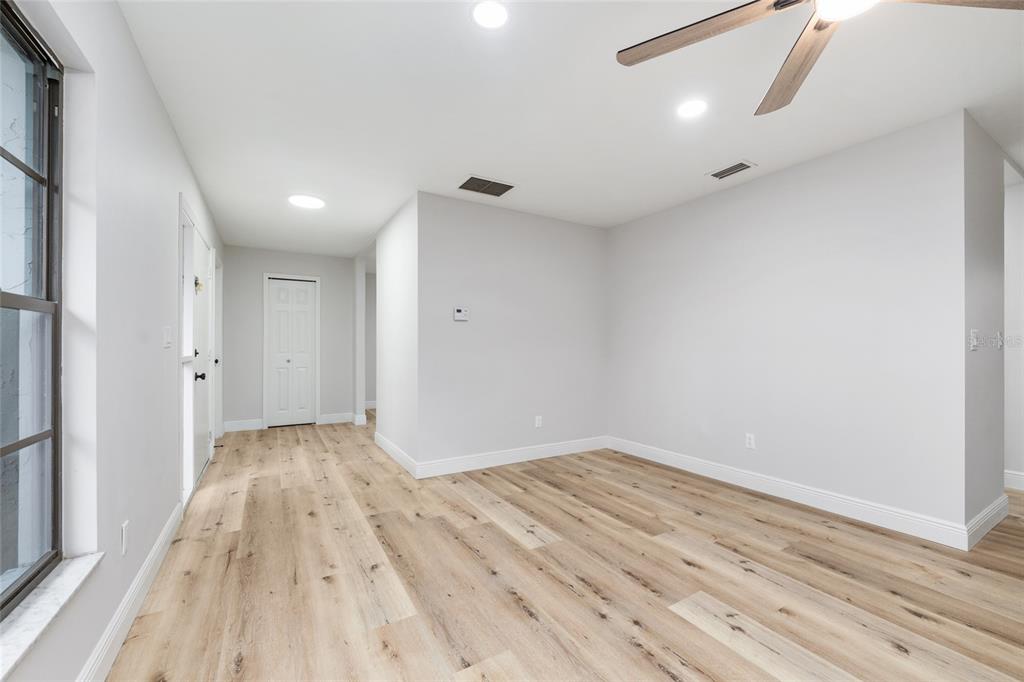 320 Southeast 41st Avenue Ocala, FL 34471 - Photo 6 of 45 a view of empty room with wooden floor and fan