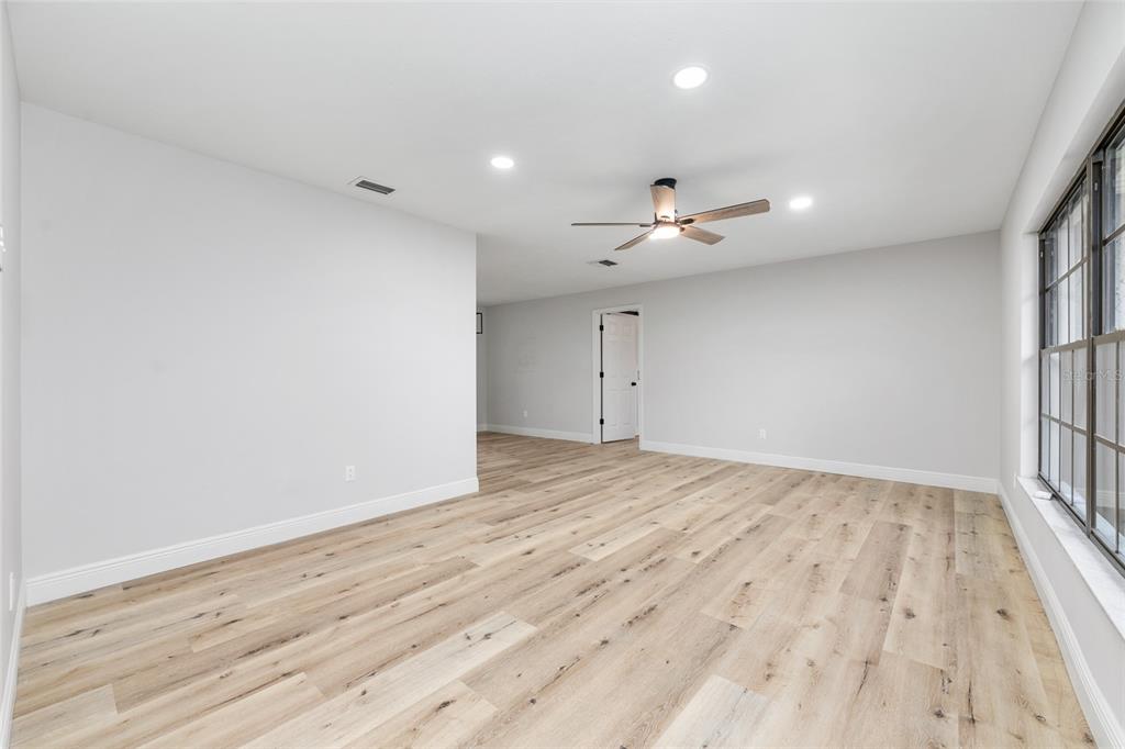 320 Southeast 41st Avenue Ocala, FL 34471 - Photo 7 of 45 wooden floor in an empty room with a window