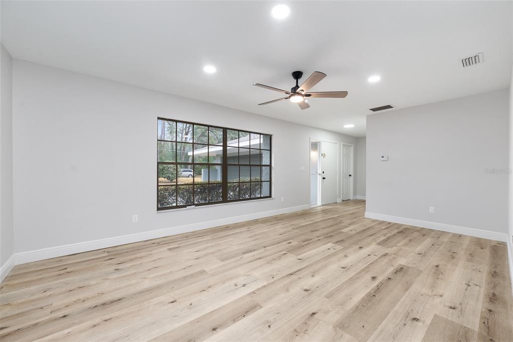320 Southeast 41st Avenue Ocala, FL 34471 - Photo 8 of 45 a view of an empty room with a window and wooden floor