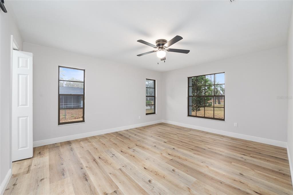 320 Southeast 41st Avenue Ocala, FL 34471 - Photo 9 of 45 a view of an empty room with a window and wooden floor