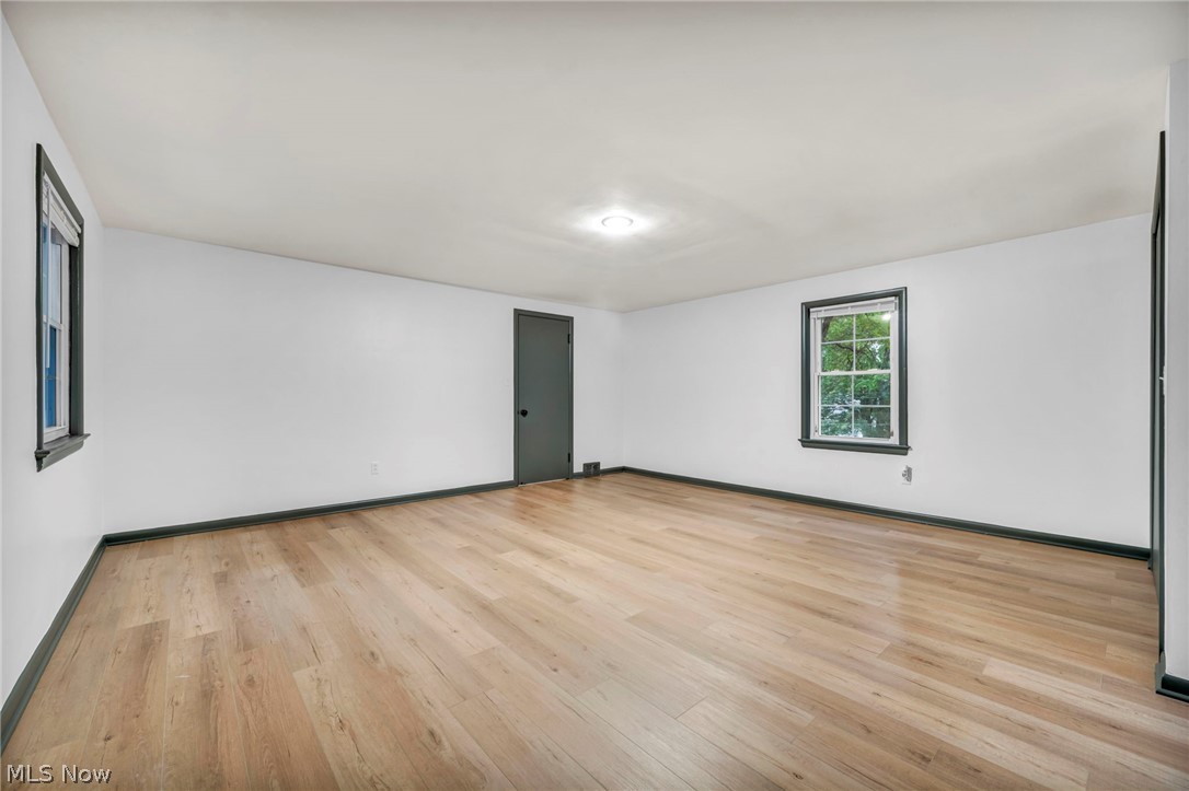 Unfurnished room with light hardwood / wood-style floors