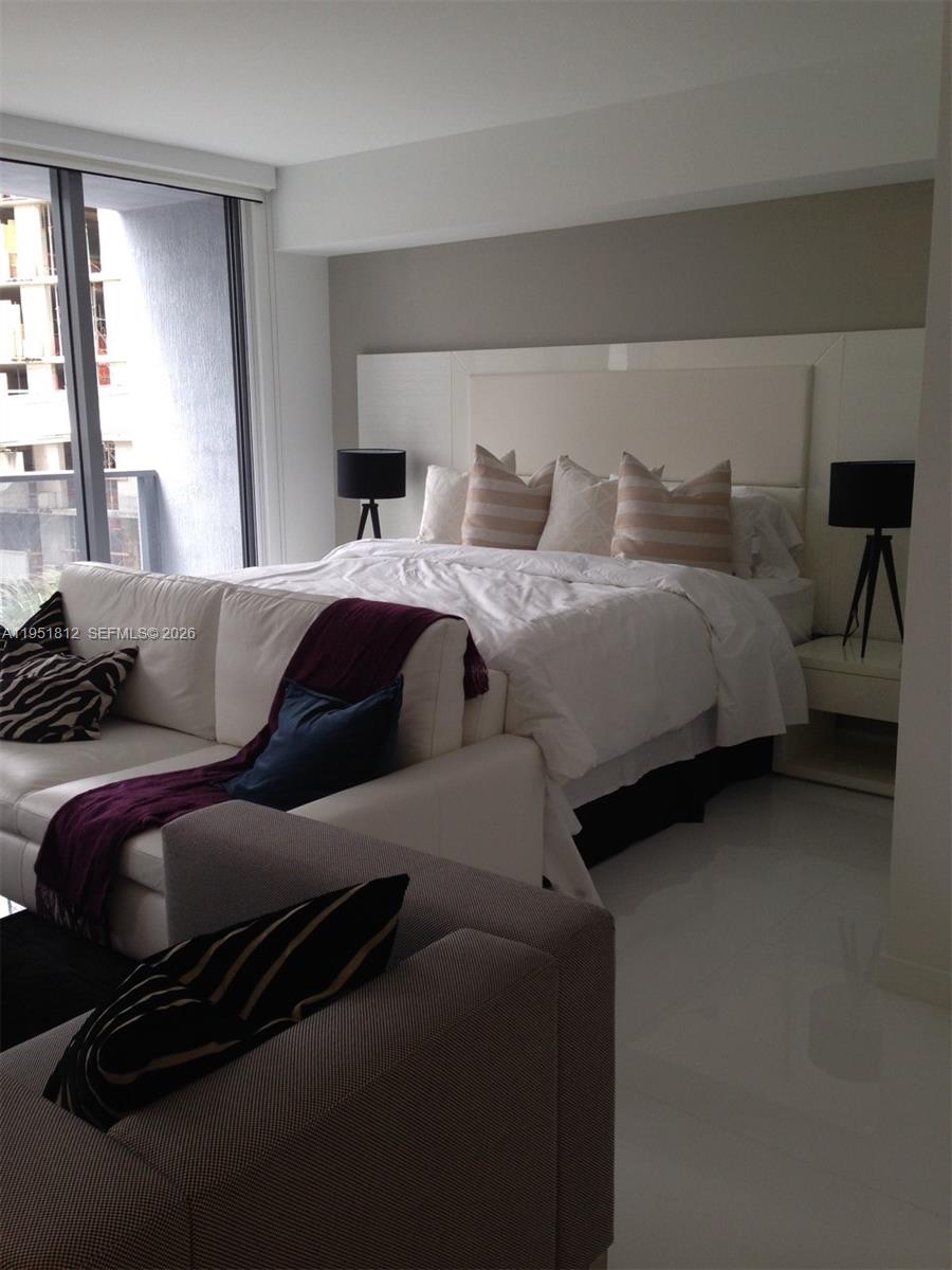 31 Southeast 6th Street, Unit 603 Miami, FL 33131 - Photo 1 of 3 a bedroom with a bed and a couch