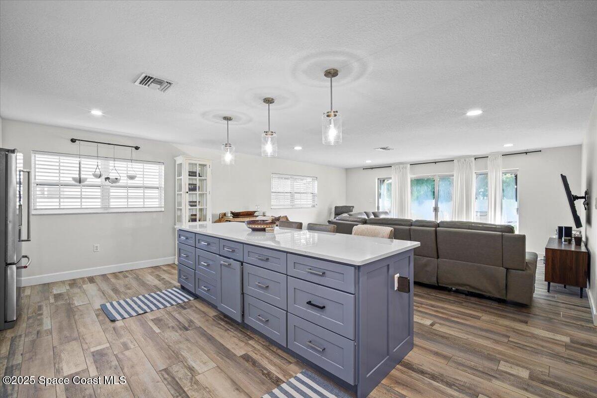 1158 Samar Road Cocoa Beach, FL 32931 - Photo 11 of 29 a kitchen with stainless steel appliances granite countertop a sink stove and refrigerator