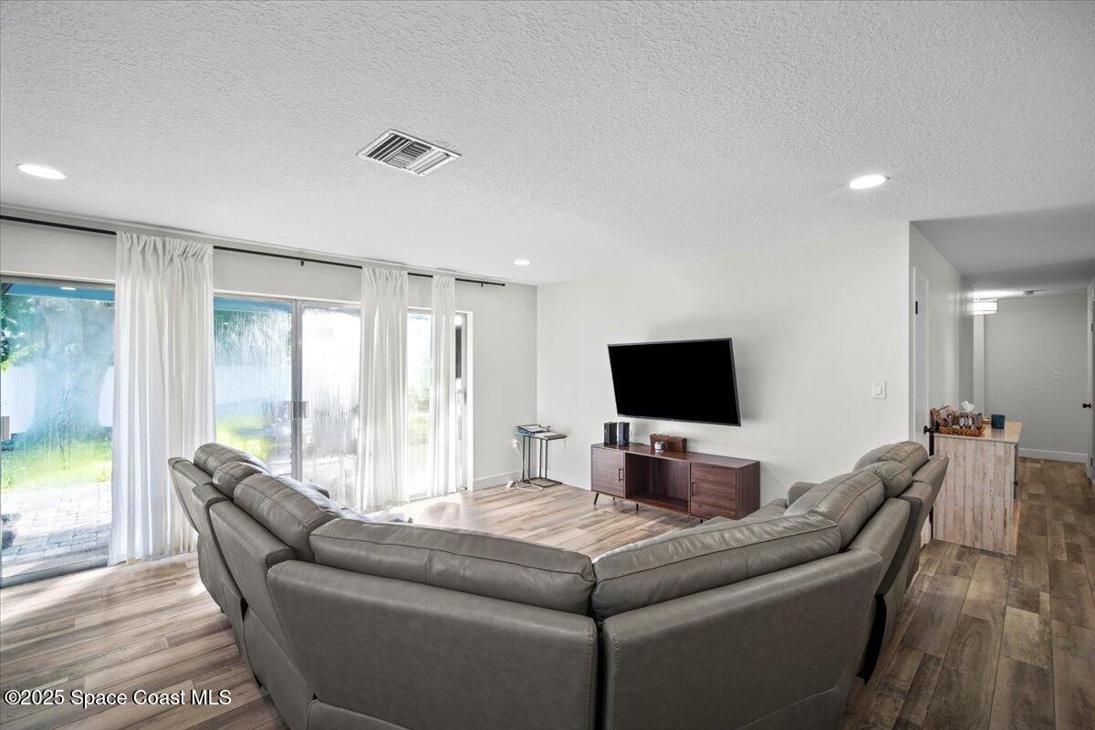 1158 Samar Road Cocoa Beach, FL 32931 - Photo 12 of 29 a living room with furniture and a flat screen tv