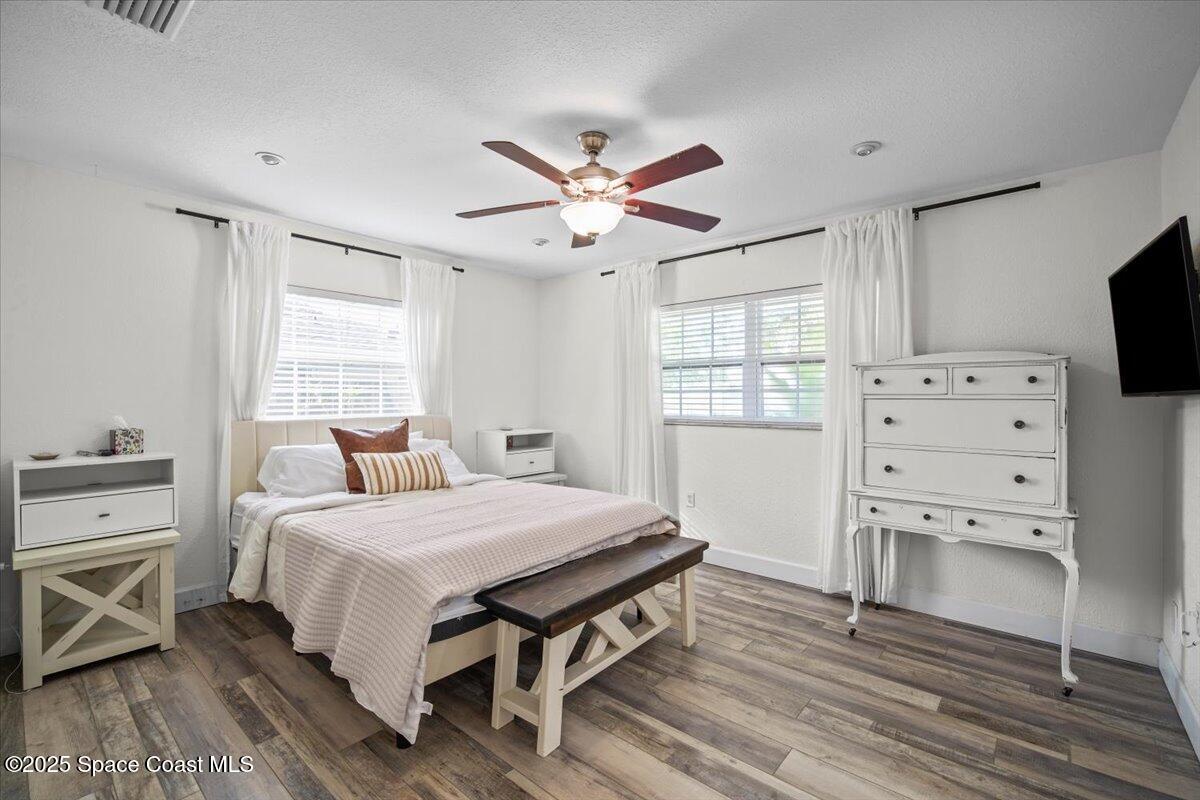 1158 Samar Road Cocoa Beach, FL 32931 - Photo 17 of 29 a bedroom with a bed and a flat screen tv