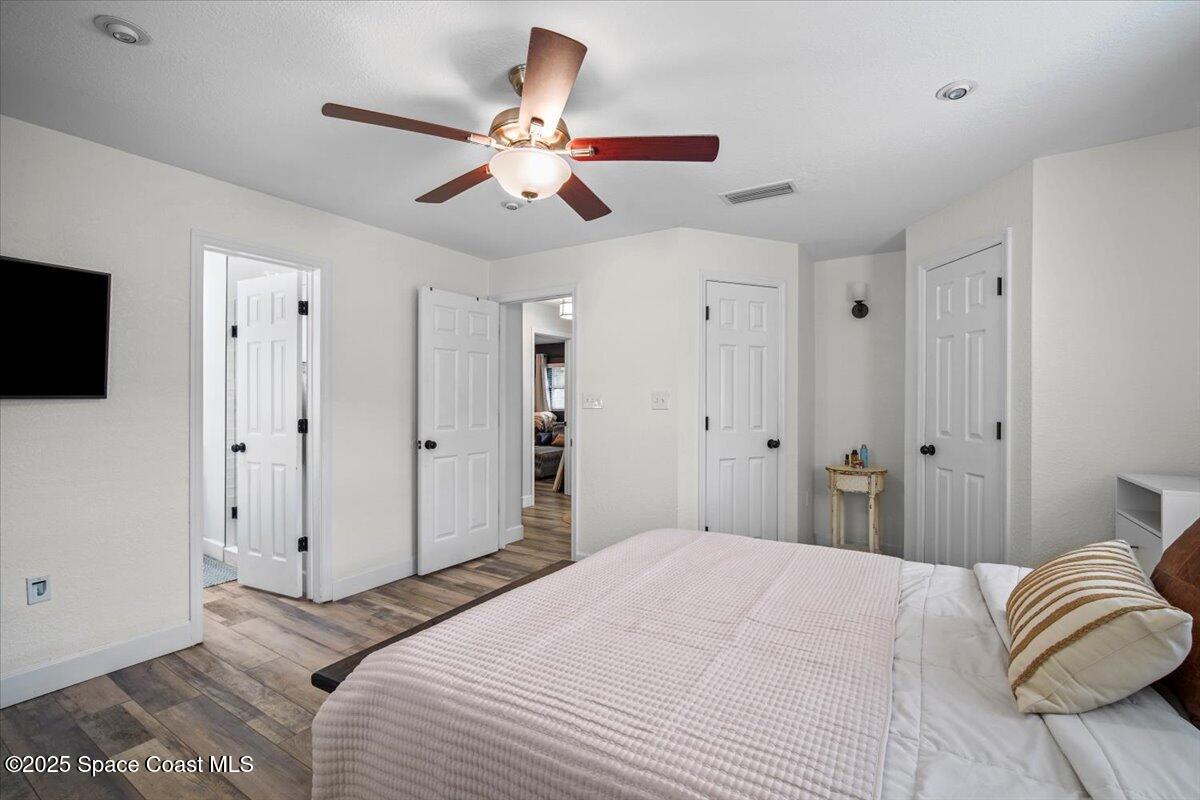 1158 Samar Road Cocoa Beach, FL 32931 - Photo 18 of 29 a bedroom with a bed and a chandelier