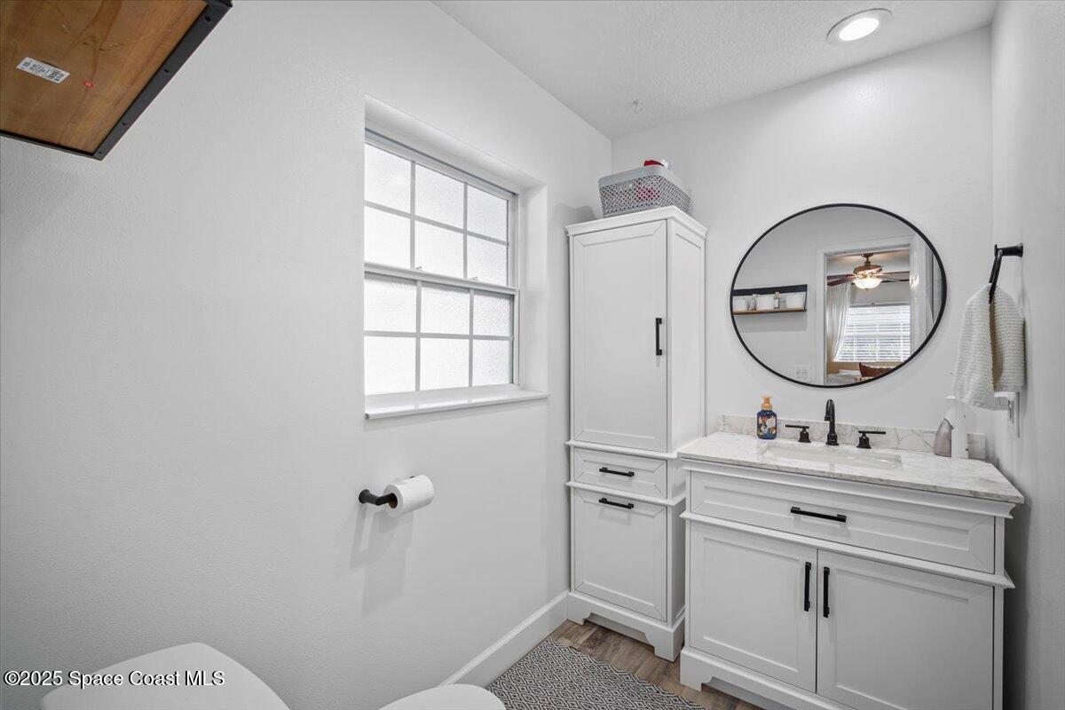 1158 Samar Road Cocoa Beach, FL 32931 - Photo 19 of 29 a bathroom with a sink mirror and a toilet