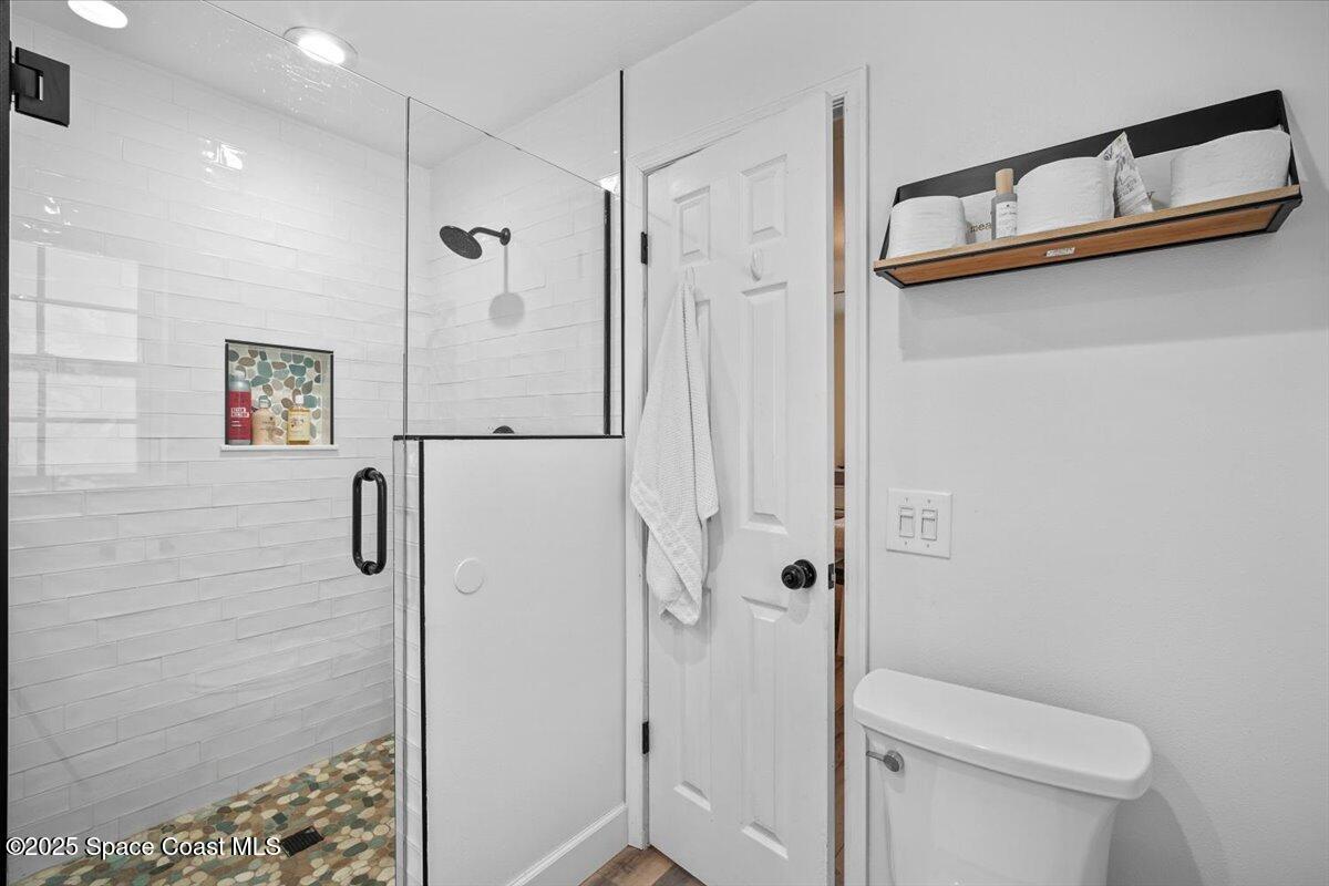 1158 Samar Road Cocoa Beach, FL 32931 - Photo 20 of 29 a bathroom with a shower a toilet and sink