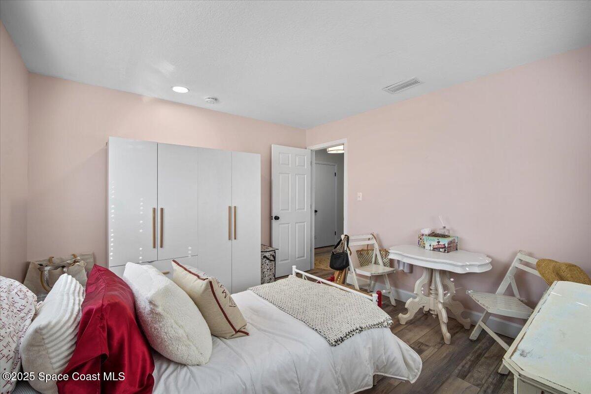 1158 Samar Road Cocoa Beach, FL 32931 - Photo 22 of 29 a bedroom with a bed and a table in it