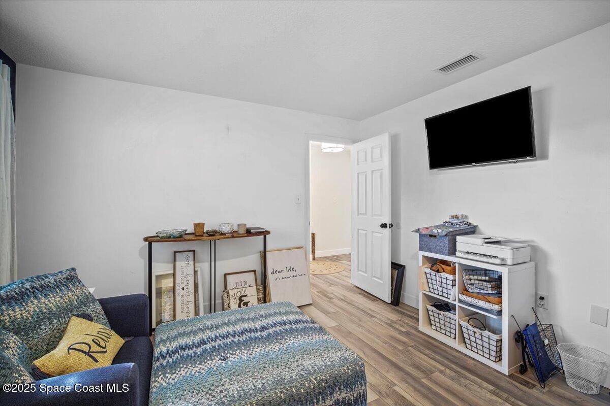 1158 Samar Road Cocoa Beach, FL 32931 - Photo 25 of 29 a living room with furniture and a flat screen tv
