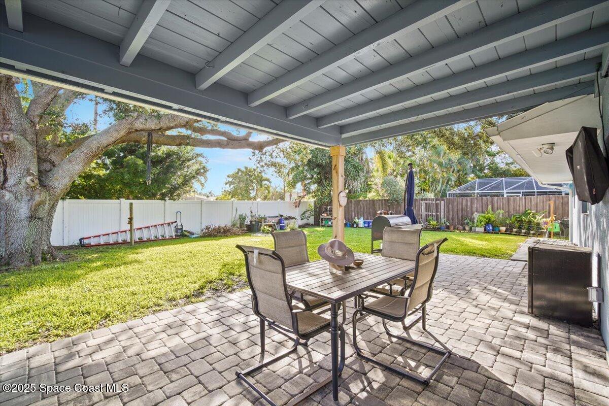 1158 Samar Road Cocoa Beach, FL 32931 - Photo 26 of 29 a dining room with furniture and a garden view