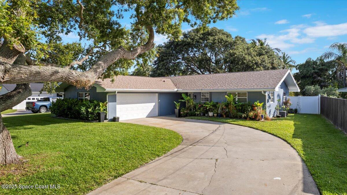 1158 Samar Road Cocoa Beach, FL 32931 - Photo 3 of 29 a front view of a house with a yard and garage
