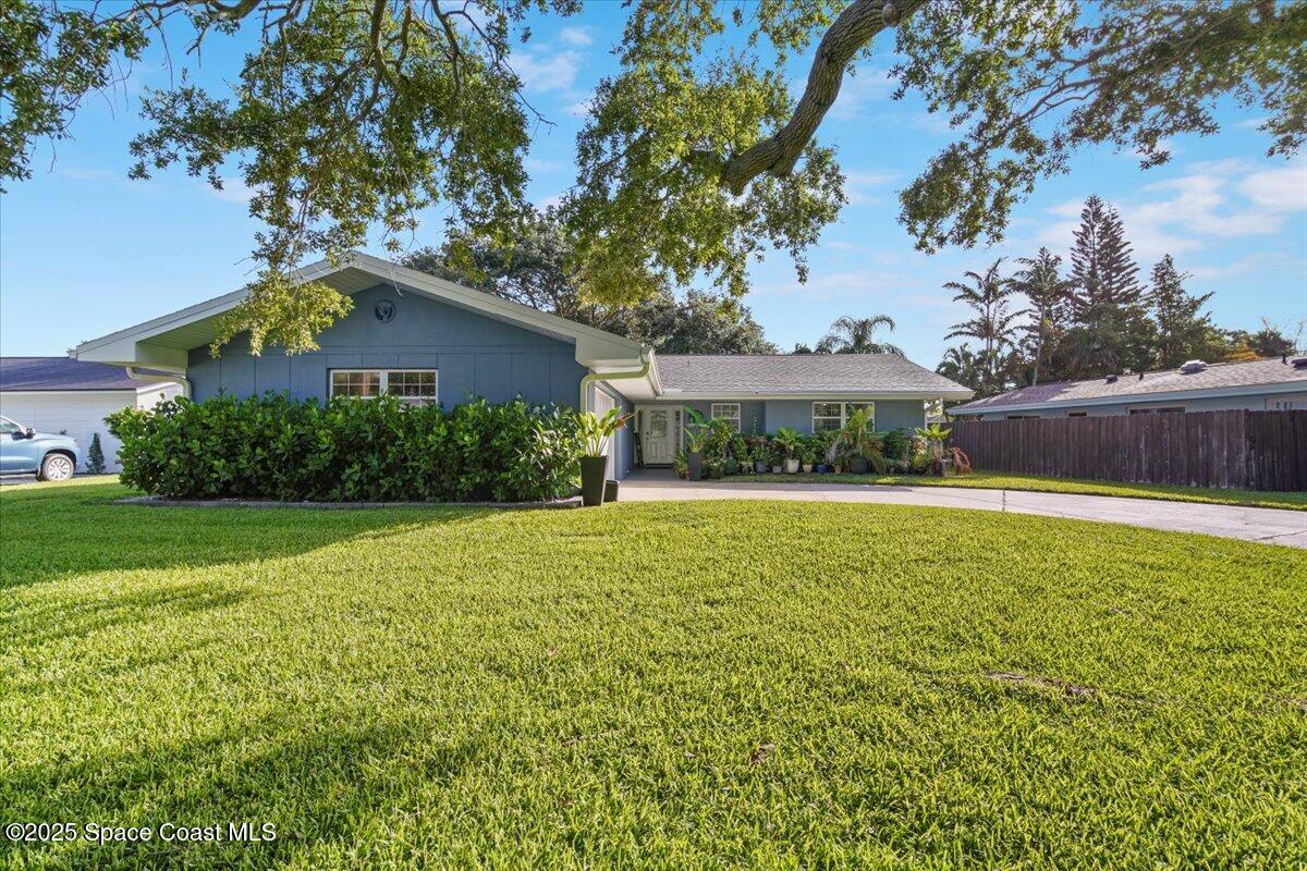 1158 Samar Road Cocoa Beach, FL 32931 - Photo 4 of 29 a front view of a house with garden