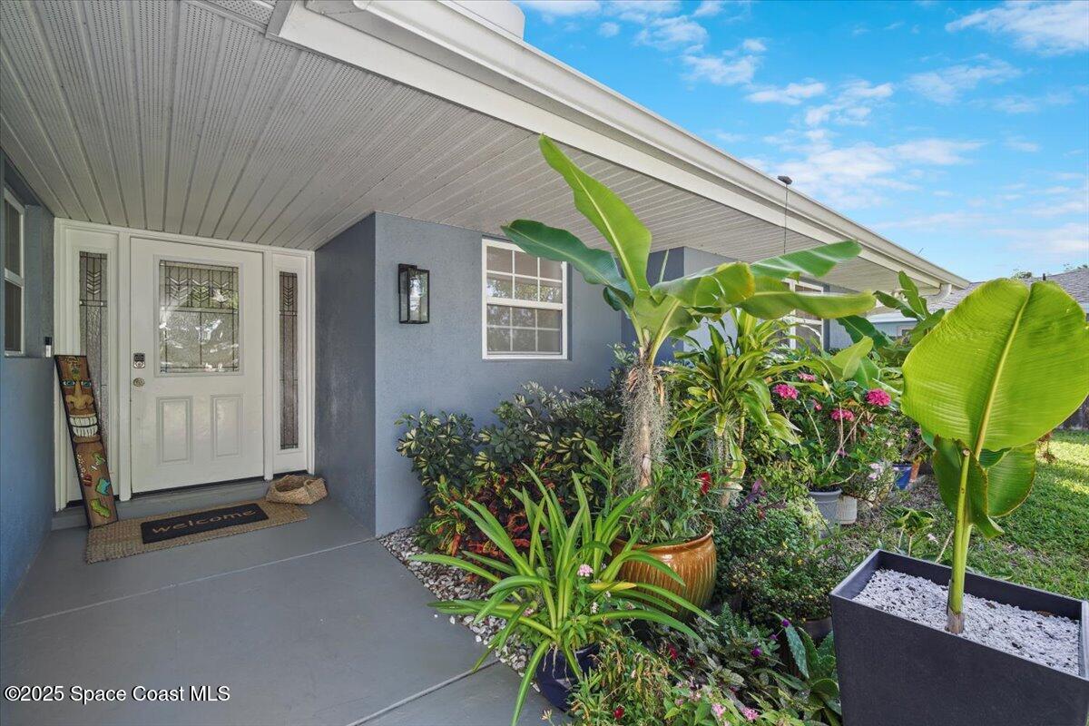 1158 Samar Road Cocoa Beach, FL 32931 - Photo 5 of 29 a front view of a house with a garden