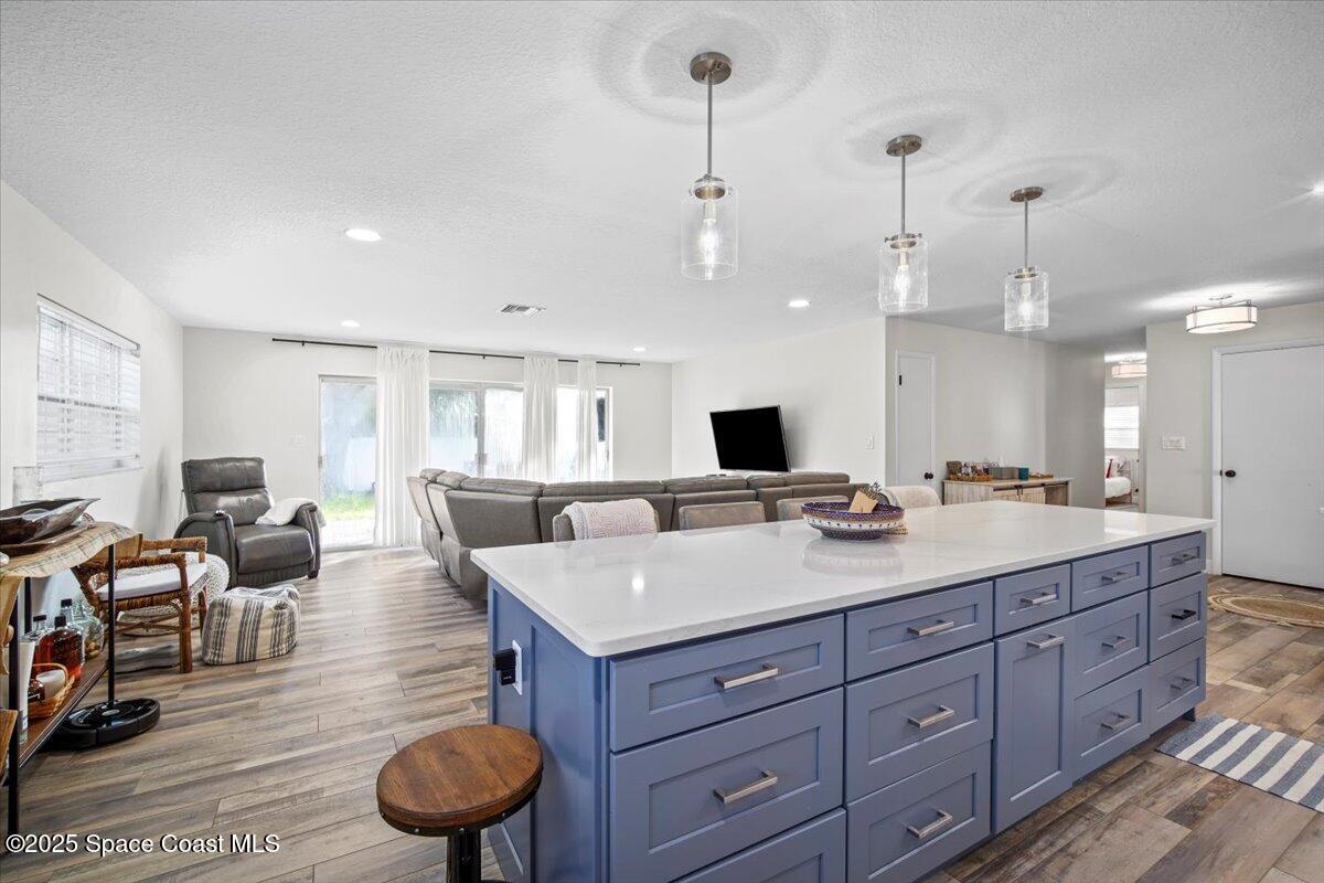 1158 Samar Road Cocoa Beach, FL 32931 - Photo 10 of 29 a living room with hard wood flooring and white walls