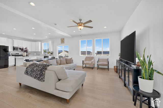 428 Quartz Road Tooele, UT 84074 - Photo 6 of 35 Expansive open-concept living area featuring light wood-finish flooring