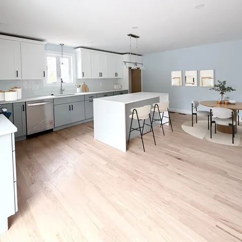 a kitchen with stainless steel appliances kitchen island granite countertop a sink and cabinets