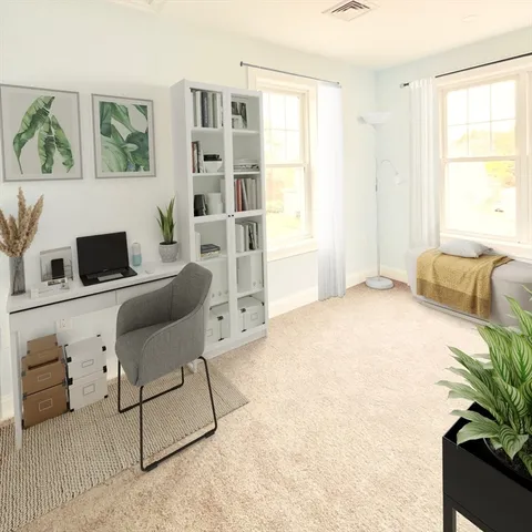 a bedroom with furniture and a large window