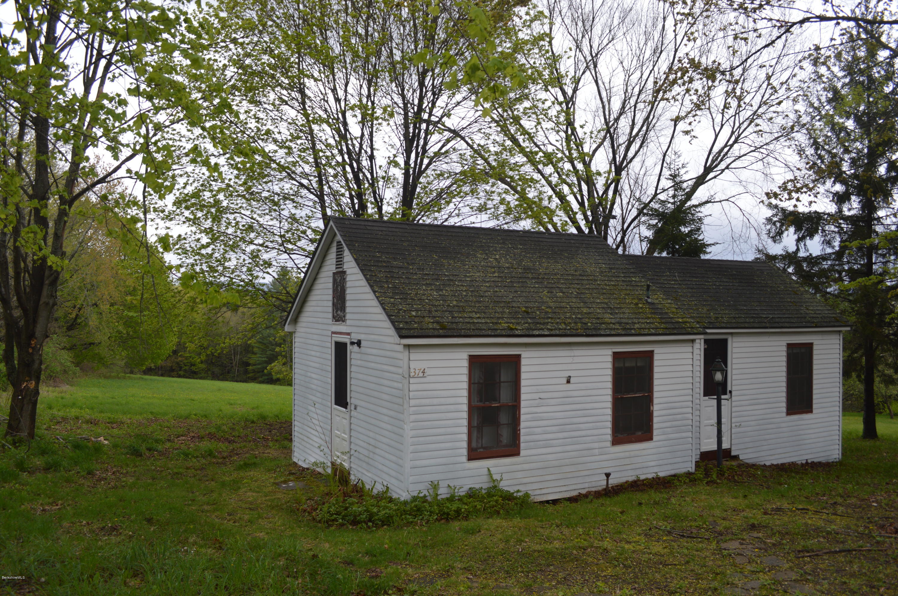374 W Road Lee, MA 01238 - Photo 1 of 15 a view of a house with a yard