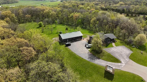 an aerial view of a house with a yard