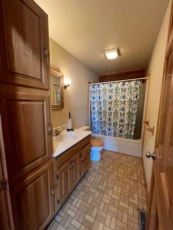 a view of hallway with mirror and a window