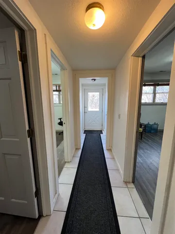 a front view of a house with cars parked