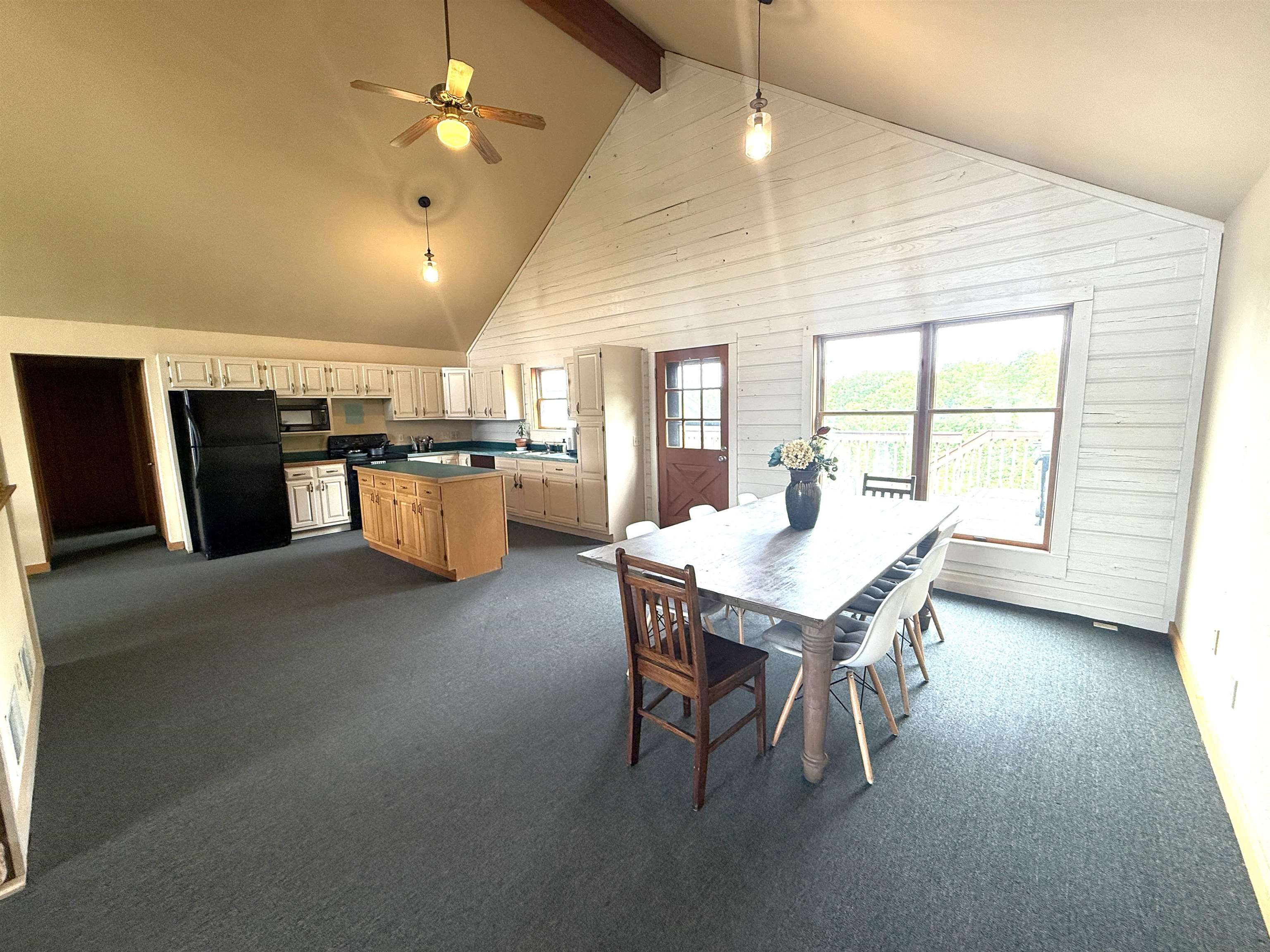 5140 Highway 20 Galena, IL 61036 - Photo 7 of 38 a dining hall with stainless steel appliances kitchen island granite countertop a table chairs and a refrigerator
