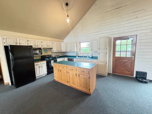 a dining room with furniture and a floor to ceiling window