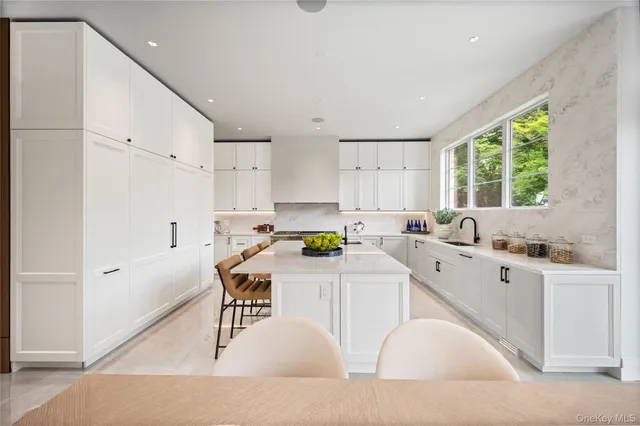 a kitchen with a sink a window and stainless steel appliances