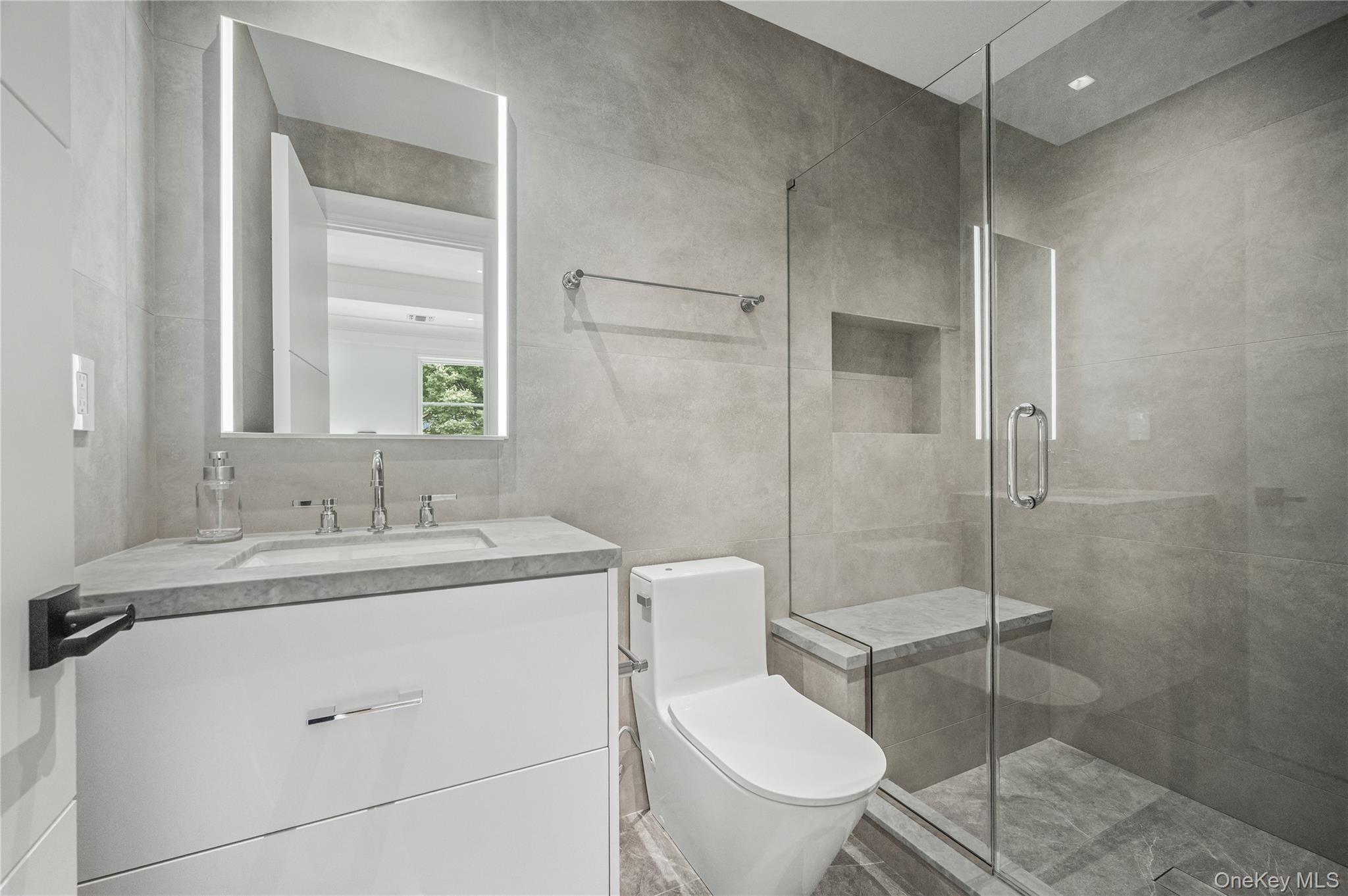 7 Mirrielees Road Great Neck, NY 11021 - Photo 30 of 47 a bathroom with a granite countertop toilet sink and mirror